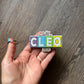 Game of Cleo Glittery Keychain/Magnet